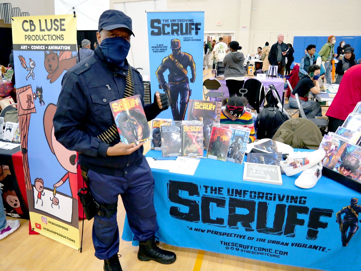 Adhim Deveaux, writer of "The Unforgiving Scruff," at "Boston Comics in Color Festival" at the Reggie Lewis Track and Athletic Center in Roxbury, April 20, 2024. (©Greg Cook photo)