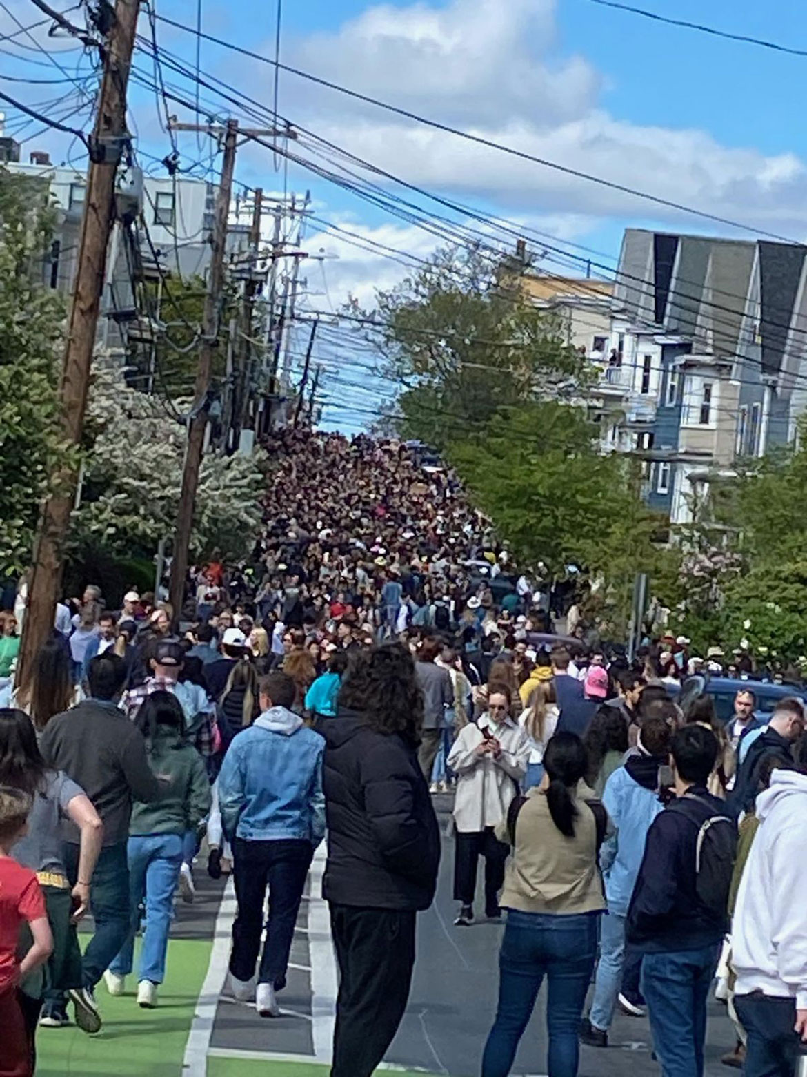 Crowd on Cedar Street trying to see Guster around the corner on Aberdeen Road during Somerville Porchfest, May 11, 2024. (Photo by Iaritza Menjivar of the Somerville Arts Council)