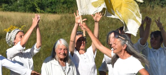 Linda Elbow runs with a flag in "Hallelujah" at Bread and Puppet, Glover, Vermont, Aug. 25, 2019. (©Greg Cook photo)