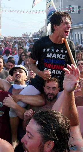 Nick White is carried up Beach Court after winning Sunday's Greasy Pole competition, June 29, 2025. (©Greg Cook photo)