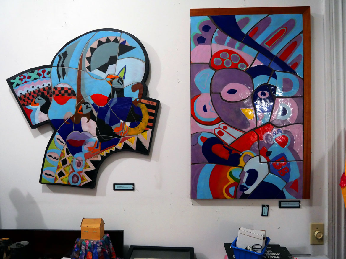 Napoleon Jones-Henderson's "Convergence '96" (left) and another enamel on copper on wood artwork in his Boston home, Oct. 4, 2025. (©Greg Cook photo)