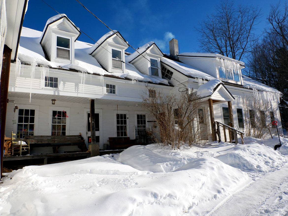 Porch of Puppeteers' House at Bread and Puppet Theater, Glover, Vermont, Feb. 9, 2026. (©Greg Cook photo)
