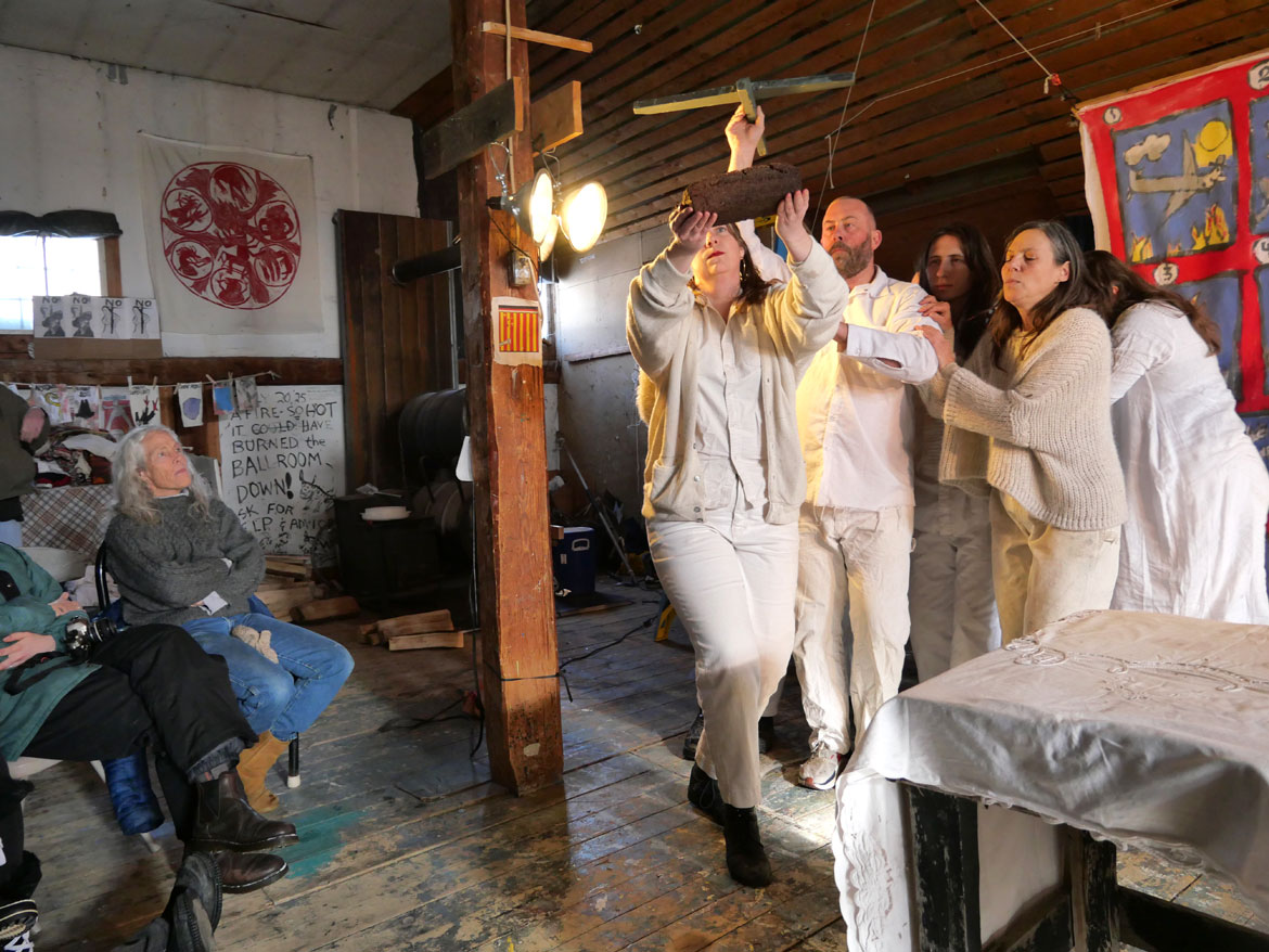 Bread and Puppet Theater performs “Life and Death Precision Dances with Happiness Obligation Prologue," the last performance of a series of winter shows in the wood-stove-heated upstairs Ballroom at the company’s snowbound Glover, Vermont, farm, Feb. 8, 2026. (©Greg Cook photo)