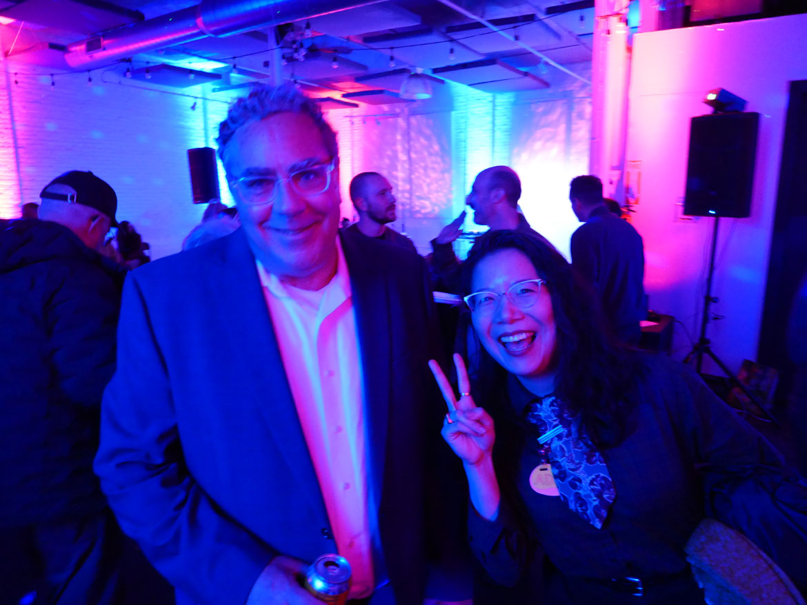 Greg Jenkins (left) and friend at "Arts in the 'Ville" party honoring Gregory Jenkins at Warehouse XI, Somerville, April 9, 2026. (©Greg Cook photo)