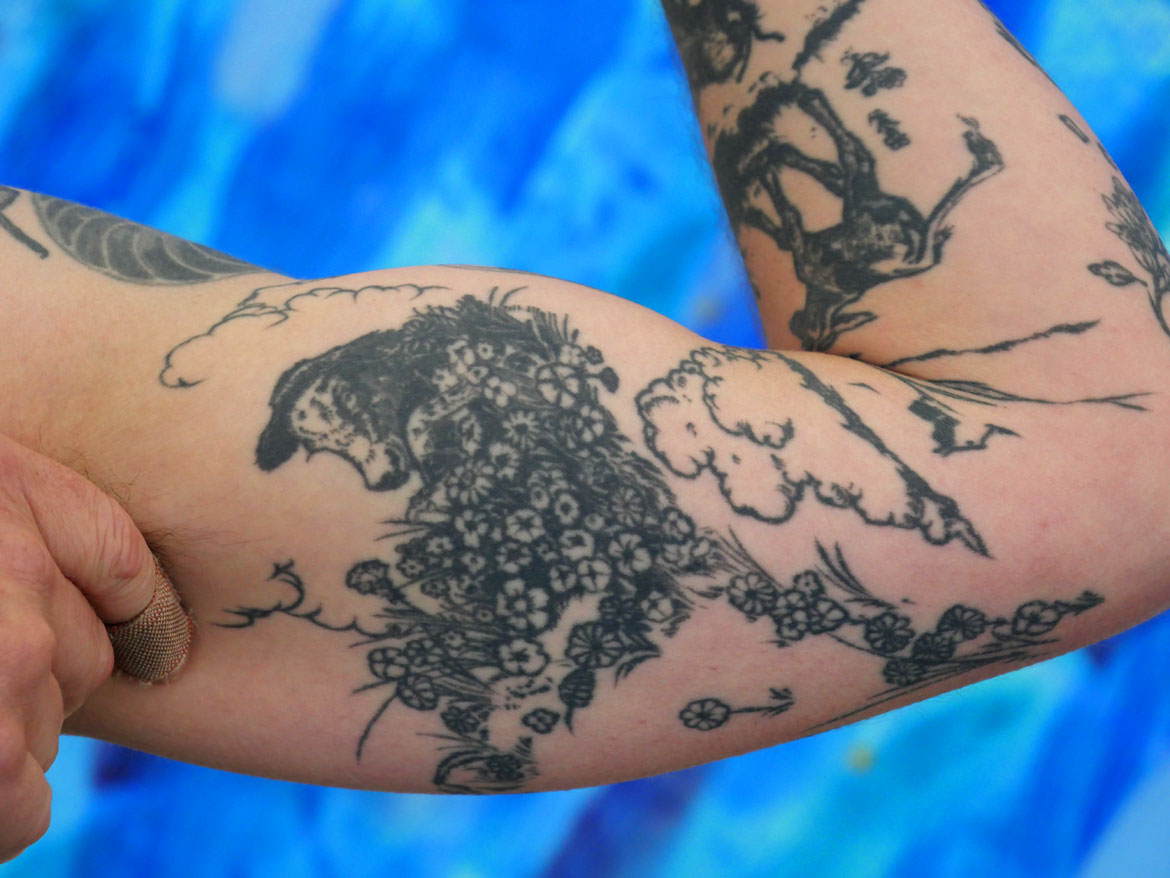 Ryan Williams's arm is tattooed with illustrations from "The Story of Ferdinand." (©Greg Cook photo)