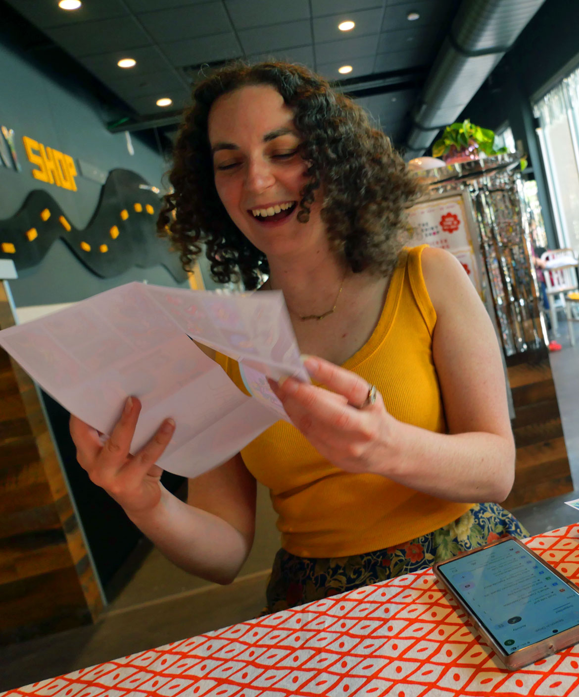 SaraMarie Bottaro of the Rabbits of Realness leads a zine-making workshop at The Shiny Shop, June 11, 2026. (©Greg Cook photo)