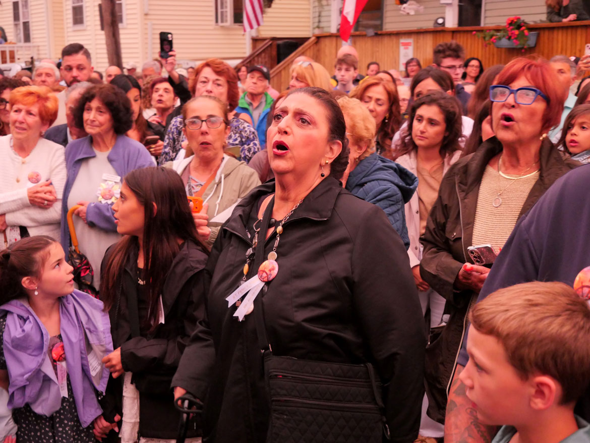 Sefatia Romeo Theken shouts blessings during the procession down to Beach Court following the last night of the Novena that begins the annual St. Peter's Fiesta, Gloucester, June 23, 2026. (©Greg Cook photo)