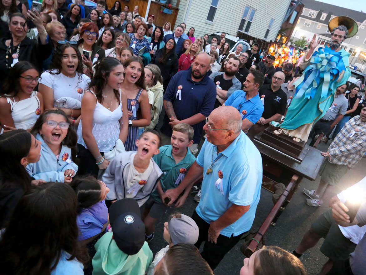Shouting blessings during the procession down to Beach Court following the last night of the Novena that begins the annual St. Peter's Fiesta, Gloucester, June 23, 2026. (©Greg Cook photo)