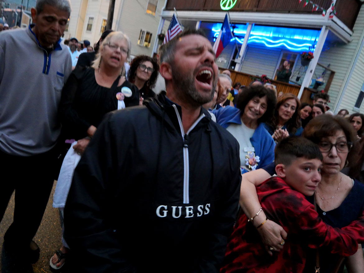 Enzo DiMaio shouts blessings during the procession down to Beach Court following the last night of the Novena that begins the annual St. Peter's Fiesta, Gloucester, June 23, 2026. (©Greg Cook photo)
