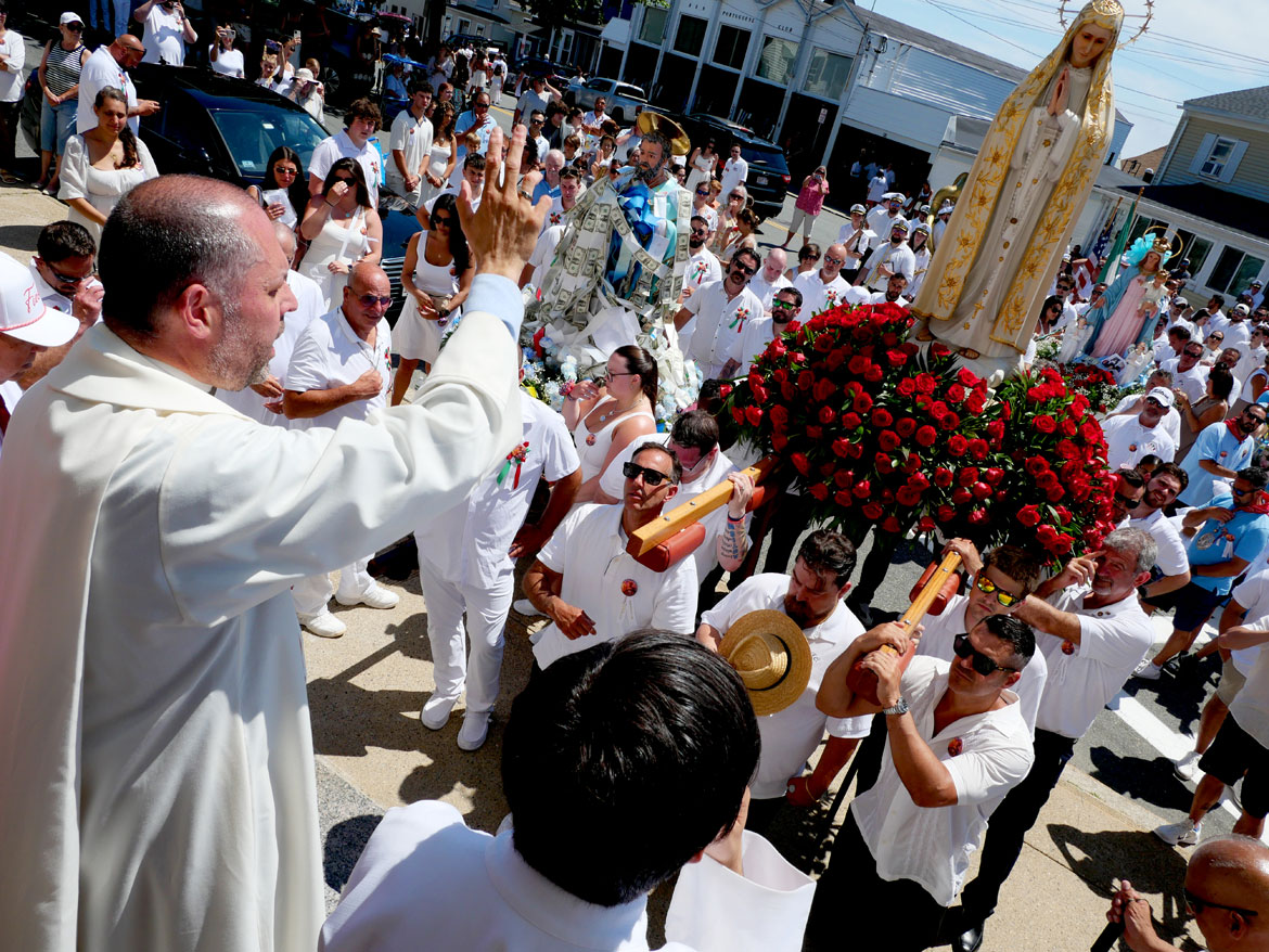 Father James Achadinha leads the crowd in prayer from the steps of Our Lady of Good Voyage Church during the St. Peter's Fiesta Sunday Procession, Gloucester, June 28, 2026. (©Greg Cook photo)