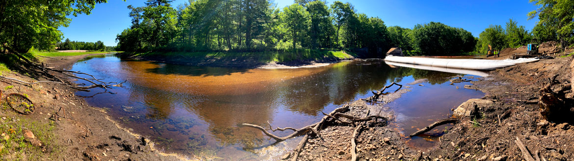 The Ware River bends around to the temporary dam installed so that the old Wheelwright Dam behind it could be removed, June 9, 2026. (©Greg Cook photo)