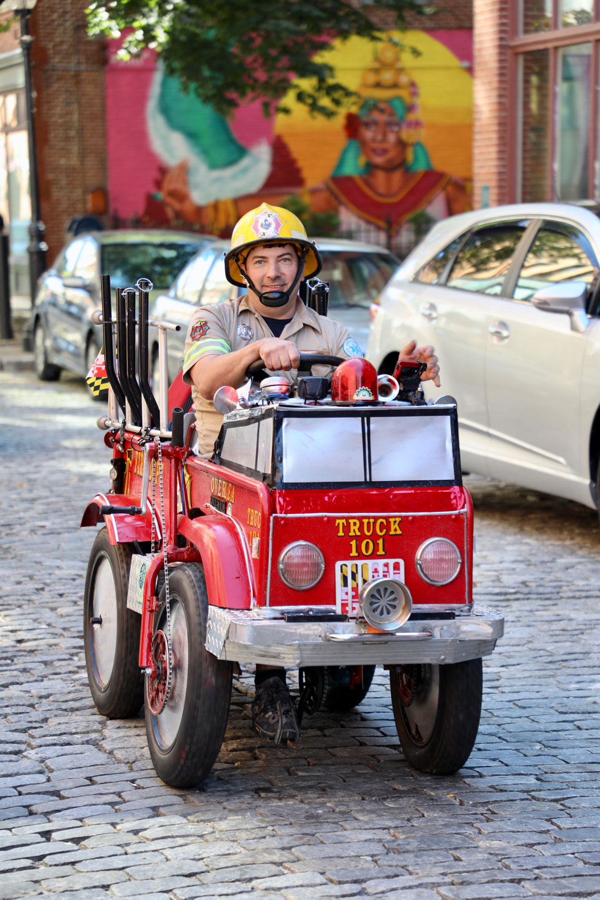 2025 Lowell Kinetic Sculpture Race: Baltimore racing friends taking Fire Truck Pedal Car down Bone Shaker Alley. (Jen Myers photo)