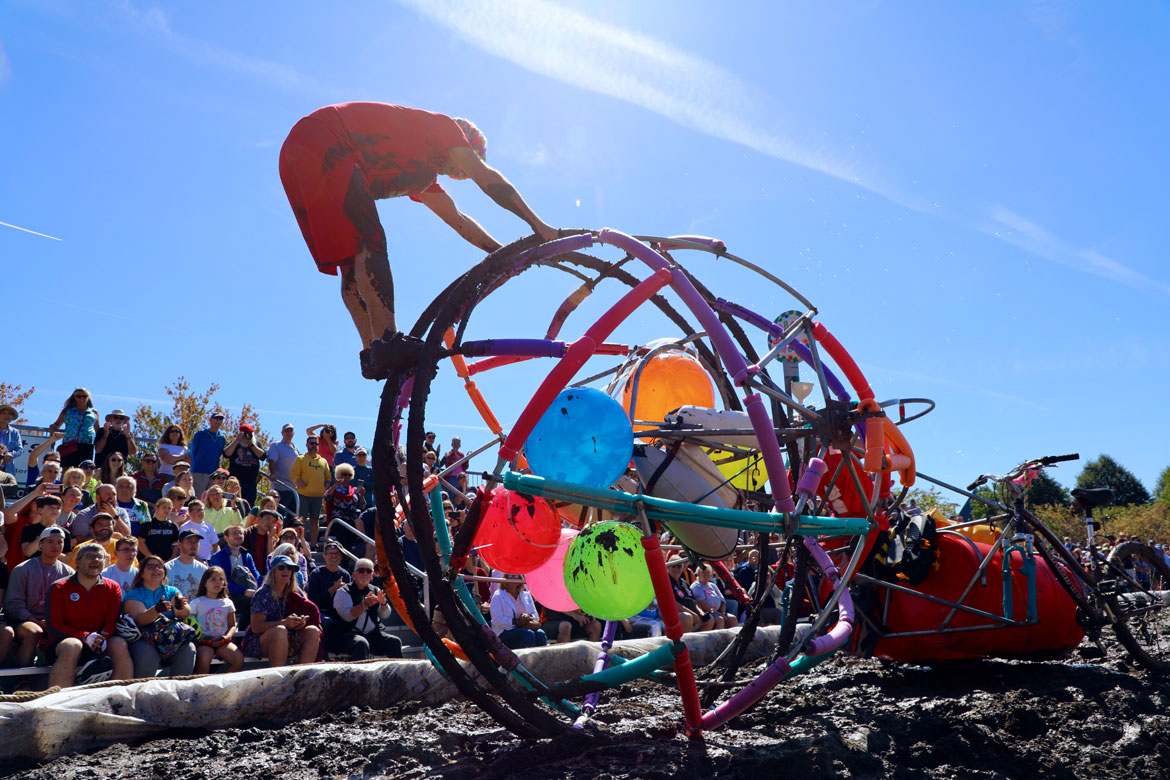 2025 Lowell Kinetic Sculpture Race: "The Big Ball," a race home sculpture, tries to physics their way through the Maddening Mud Pit. (Jen Myers photo)