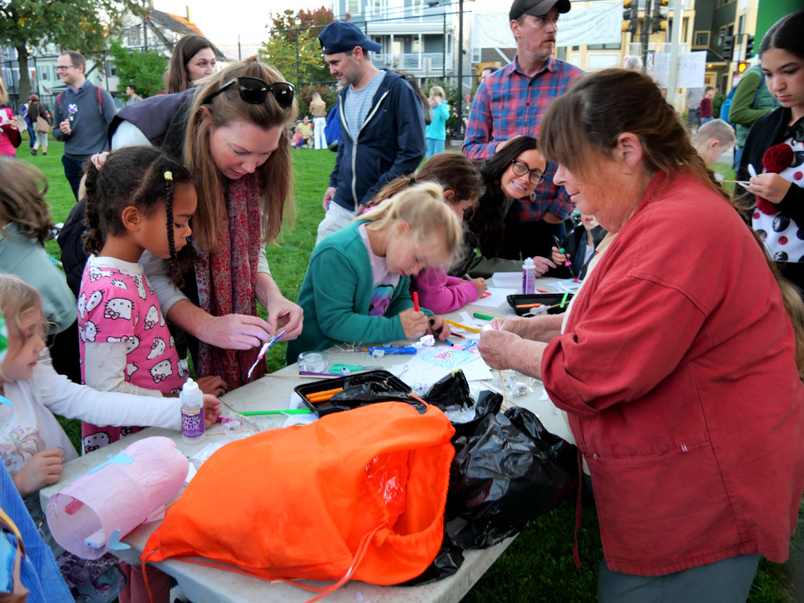 Sara Peattie of Boston Puppeteers Cooperative leads a lantern-making workshop in Somerville's Hodgkins-Curtin Park before lantern parades around the neighborhood. Friday, Oct. 9, 2026. (©Greg Cook photo)